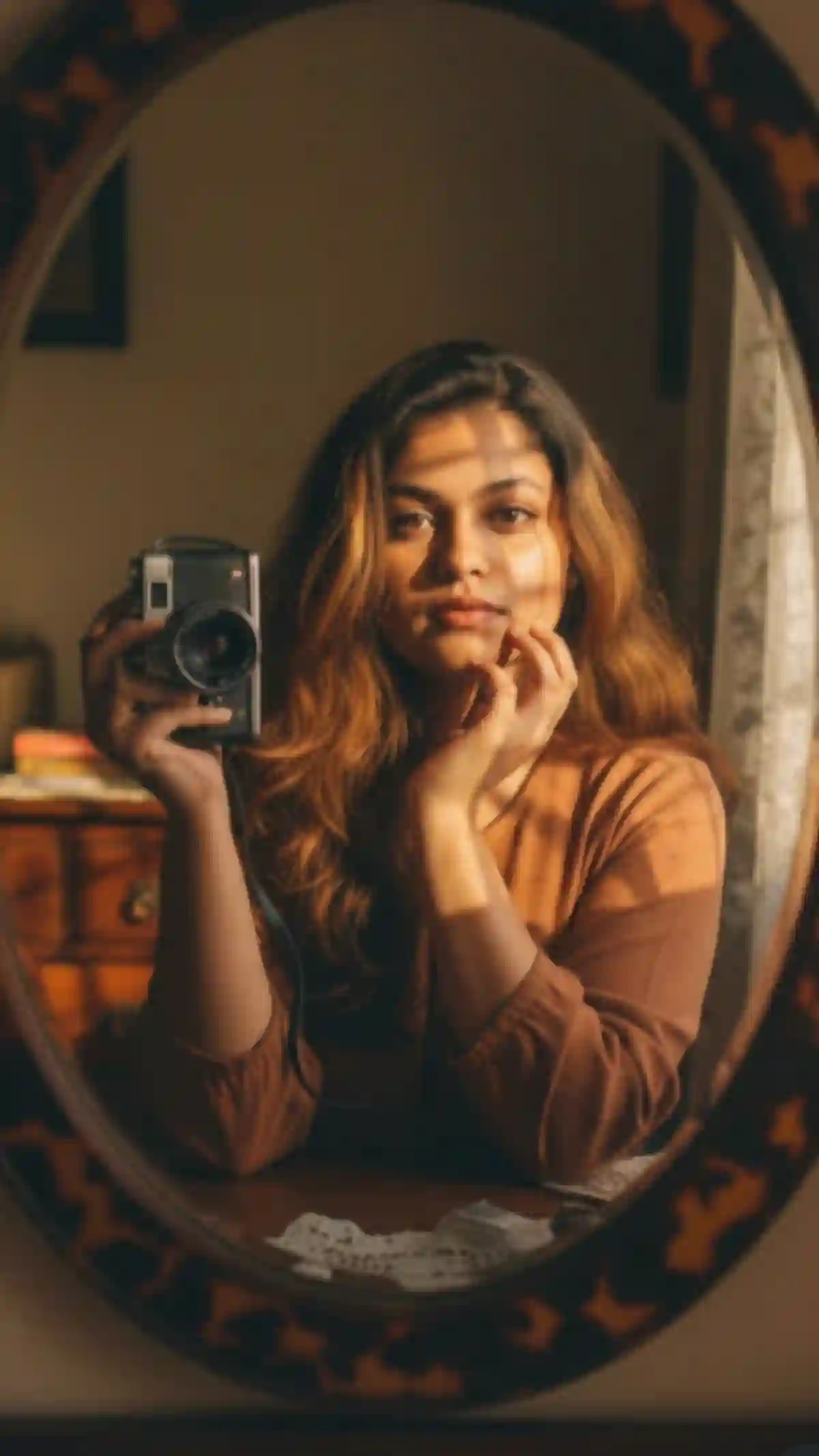 Vintage Mirror Self-Portrait of a Young Woman with Kodak Camera in Natural Afternoon Light