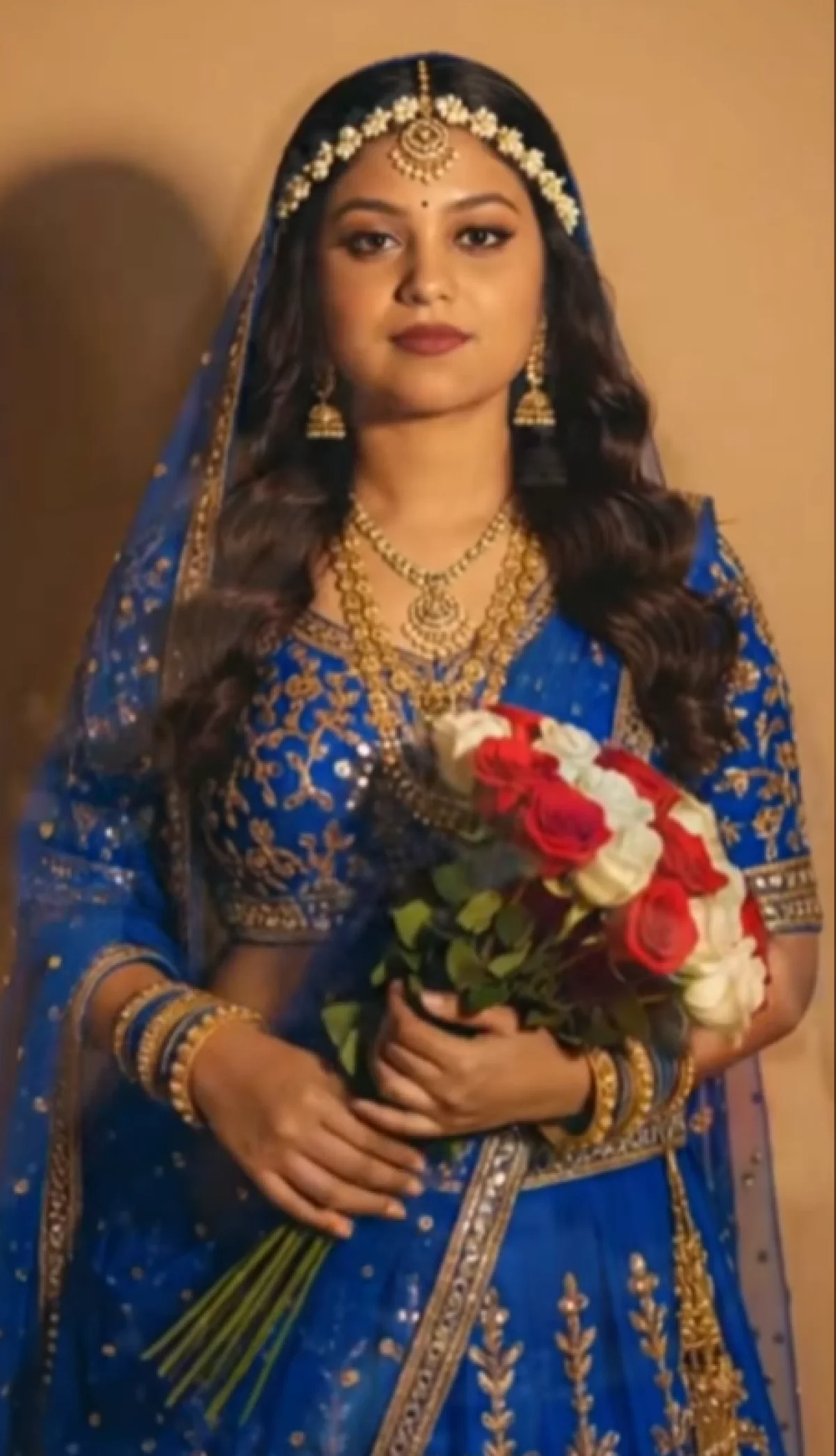 Elegant Indian Bridal Beauty in a Royal Blue Lehenga with Gold Embroidery