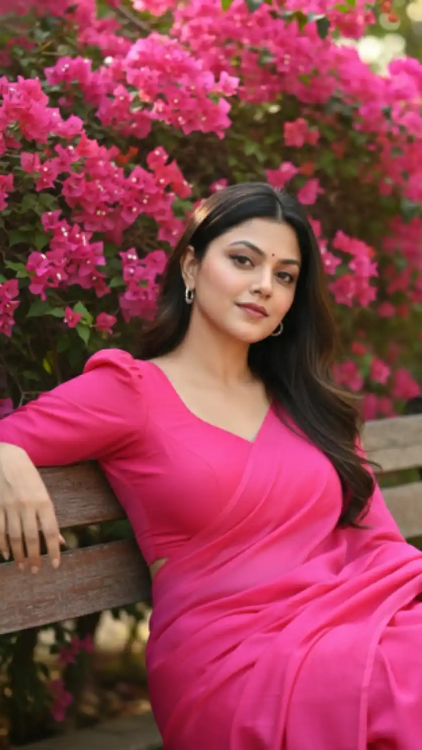 Beautiful Indian Woman in Pink Saree Sitting by Bougainvillea Flowers – Outdoor Portrait